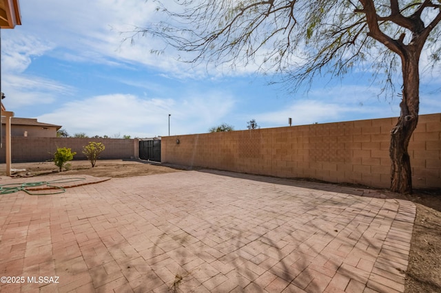 view of patio / terrace with a fenced backyard and a gate