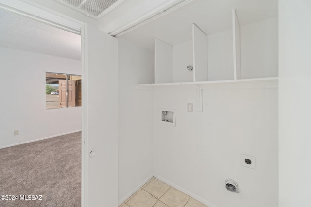 laundry area featuring light colored carpet, light tile patterned floors, laundry area, hookup for a washing machine, and electric dryer hookup