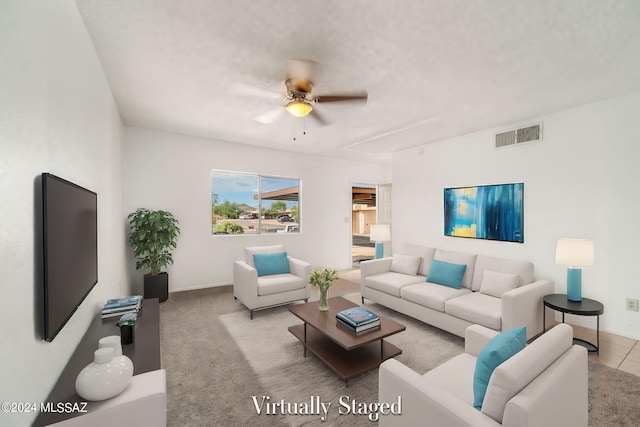 living area featuring carpet flooring, a ceiling fan, visible vents, and baseboards