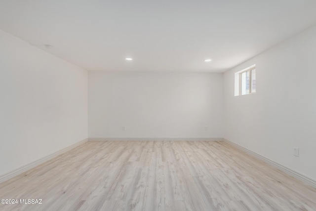 empty room with recessed lighting, baseboards, and wood finished floors