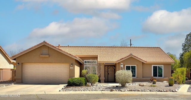 single story home with stucco siding, an attached garage, driveway, and a tiled roof