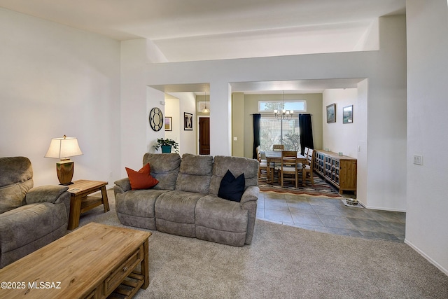 carpeted living area with tile patterned floors and a notable chandelier