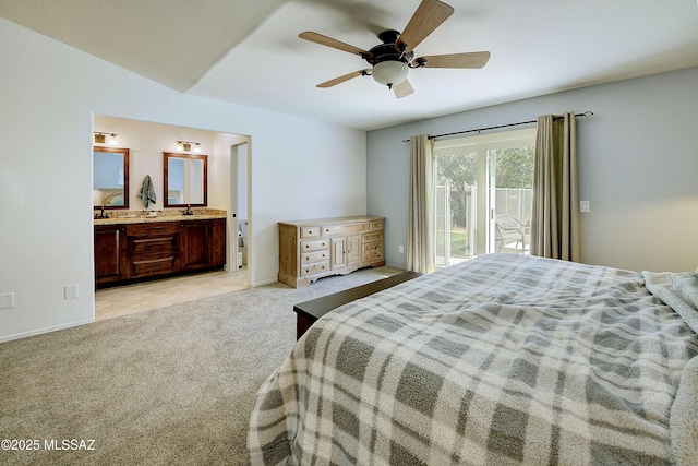 bedroom with ensuite bath, access to outside, light colored carpet, and baseboards