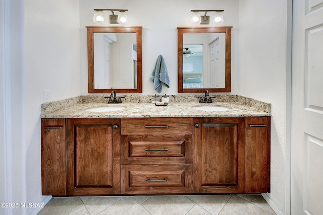 bathroom with double vanity, tile patterned floors, and a sink