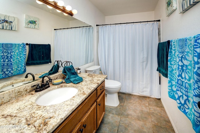 bathroom featuring vanity, toilet, and tile patterned flooring