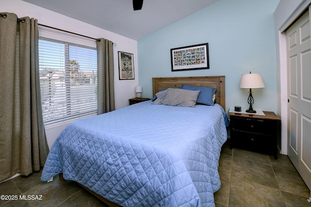 bedroom with vaulted ceiling and a ceiling fan