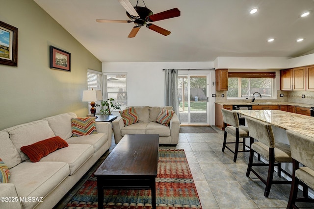 living area featuring a ceiling fan, lofted ceiling, light tile patterned floors, and recessed lighting