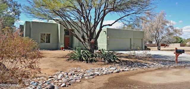 pueblo revival-style home with stucco siding