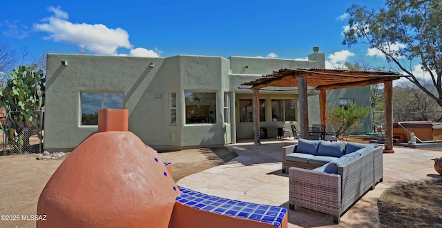 back of property featuring a patio, stucco siding, an outdoor living space, and a hot tub