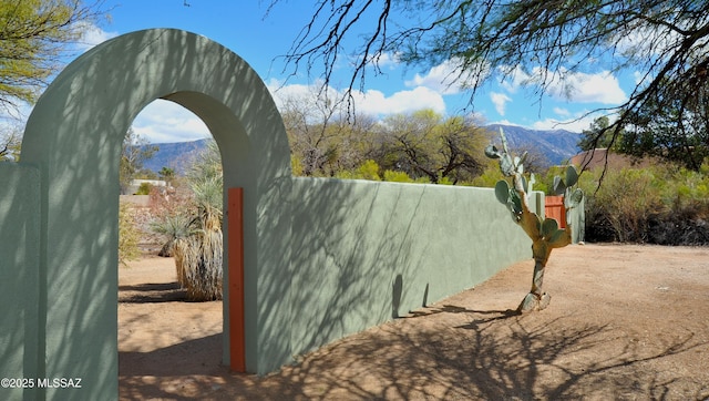 exterior space with fence and a mountain view