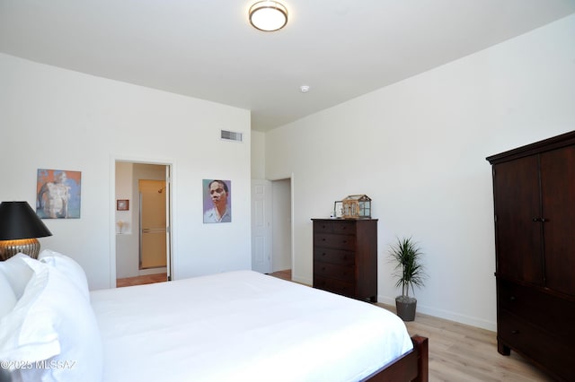 bedroom featuring visible vents, baseboards, and light wood-style flooring