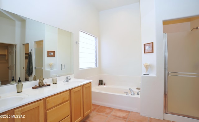 bathroom featuring tile patterned flooring, a shower stall, double vanity, a bath, and a sink