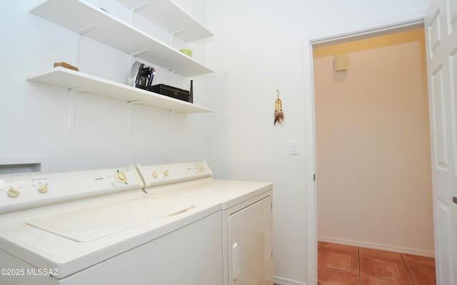 laundry room with light tile patterned floors, laundry area, baseboards, and separate washer and dryer