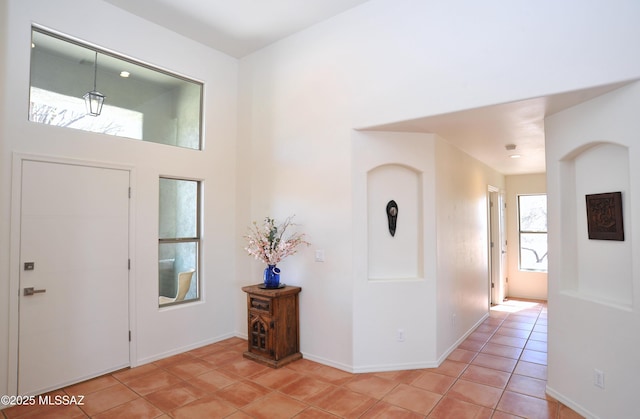 foyer with light tile patterned floors and baseboards