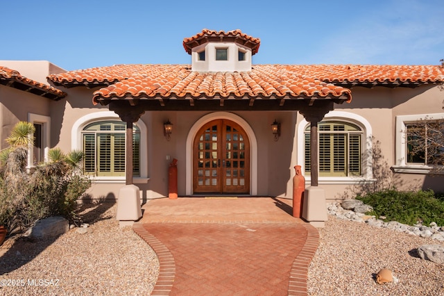 property entrance with french doors and stucco siding