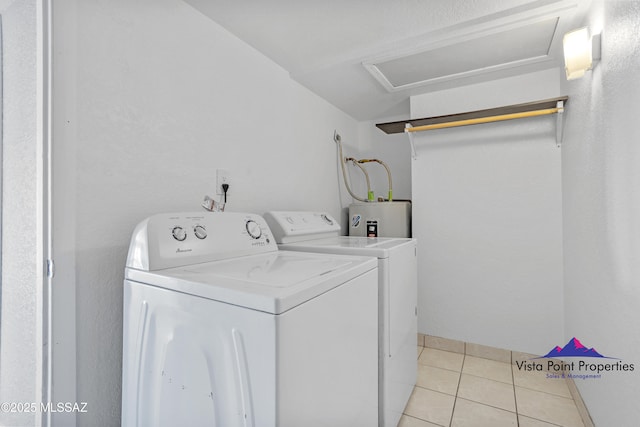 laundry room with light tile patterned floors, laundry area, washing machine and dryer, and electric water heater