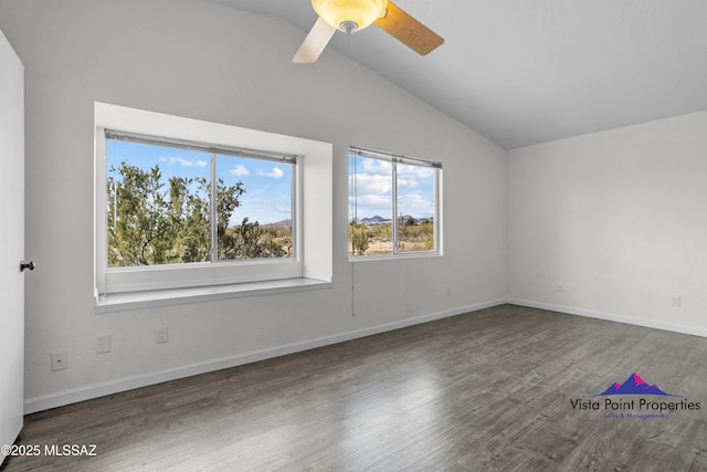 spare room featuring a ceiling fan, lofted ceiling, wood finished floors, and baseboards