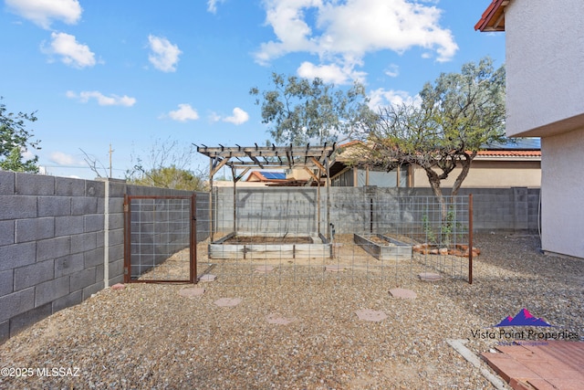 view of yard featuring a garden and a fenced backyard