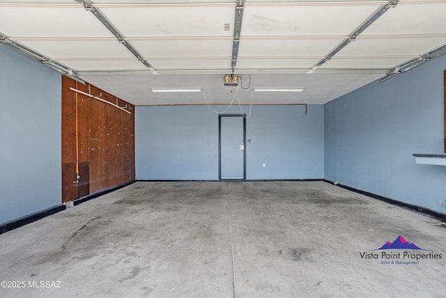 garage featuring baseboards and a garage door opener