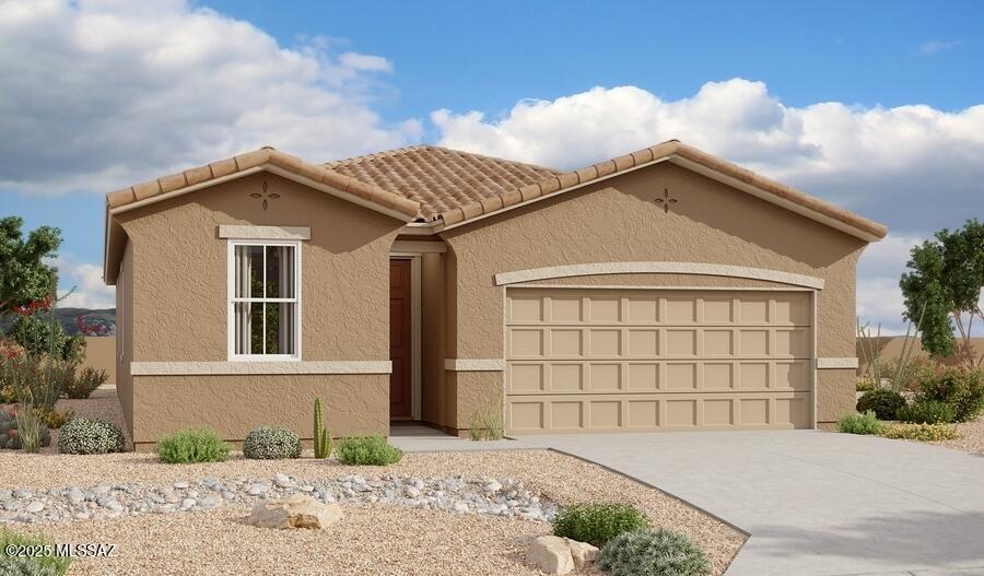 view of front of property with stucco siding, a garage, concrete driveway, and a tile roof