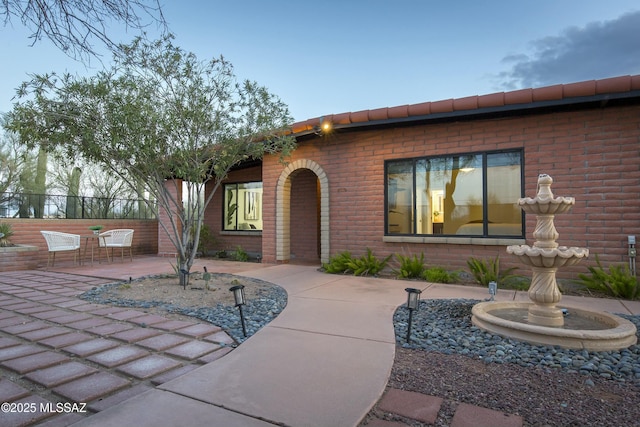 5391 W El Camino Del Cerro, Tucson, AZ 85745 - view of front of house featuring a patio, brick siding, and fence