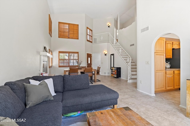 715 W Annandale Way, Tucson, AZ 85737 - living room featuring stairs, high vaulted ceiling, arched walkways, and baseboards
