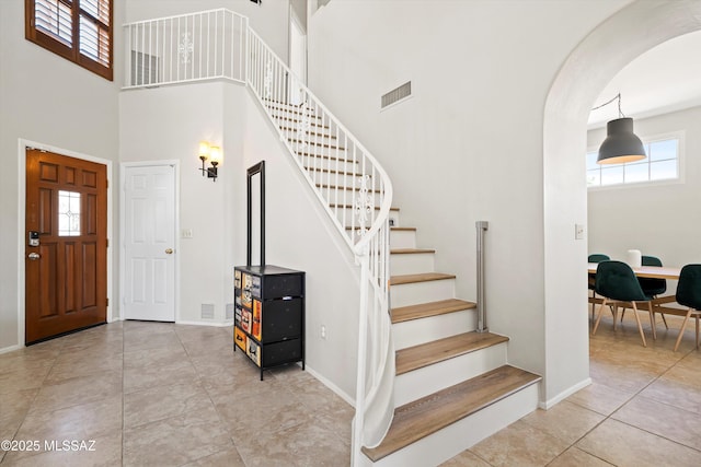 715 W Annandale Way, Tucson, AZ 85737 - tiled entryway with arched walkways, stairway, a high ceiling, and baseboards
