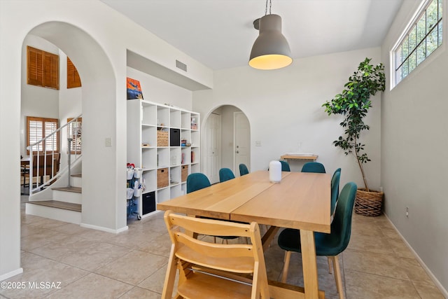 715 W Annandale Way, Tucson, AZ 85737 - dining area with arched walkways, healthy amount of natural light, light tile patterned floors, and stairway
