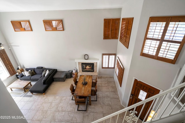 715 W Annandale Way, Tucson, AZ 85737 - living area featuring a premium fireplace, ceiling fan, and a high ceiling