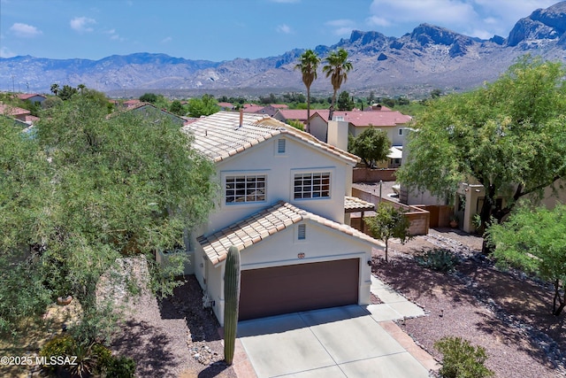 715 W Annandale Way, Tucson, AZ 85737 - mediterranean / spanish-style home featuring a tiled roof, stucco siding, driveway, a mountain view, and a garage