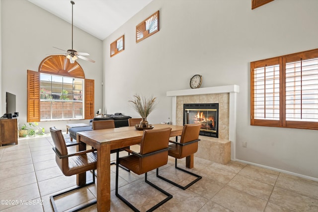 715 W Annandale Way, Tucson, AZ 85737 - dining room featuring high vaulted ceiling, tile patterned floors, a fireplace, a ceiling fan, and baseboards