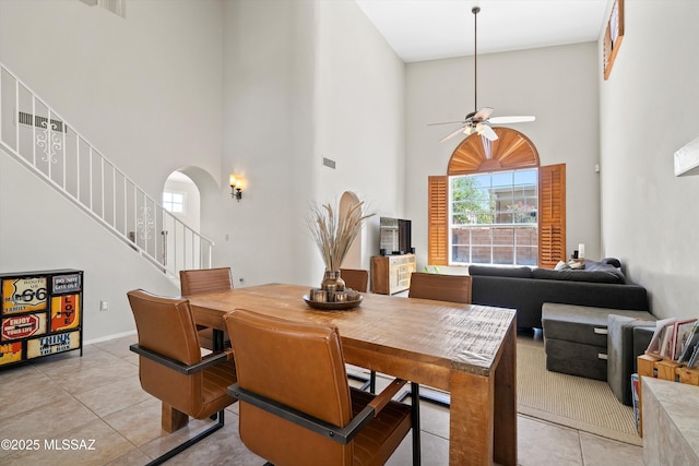 715 W Annandale Way, Tucson, AZ 85737 - dining room featuring a towering ceiling, light tile patterned floors, a ceiling fan, healthy amount of natural light, and arched walkways