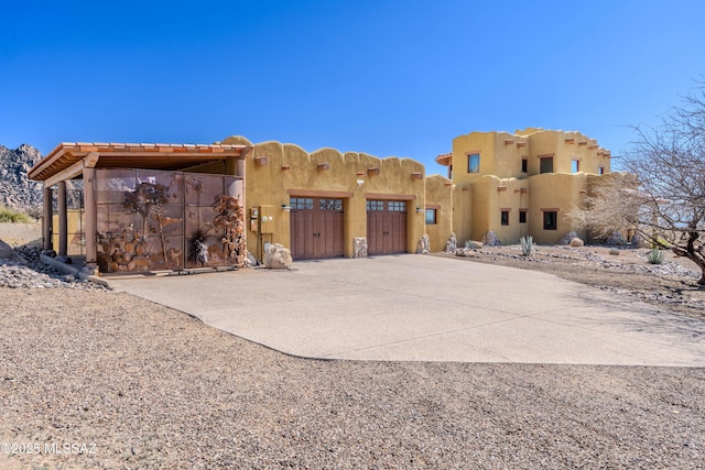 8060 E Diamondback Rd, Saint David, AZ 85630 - pueblo-style home with driveway, a gate, and a garage