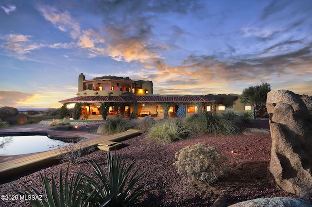 8060 E Diamondback Rd, Saint David, AZ 85630 - rear view of house with a swimming pool, a tile roof, and stucco siding