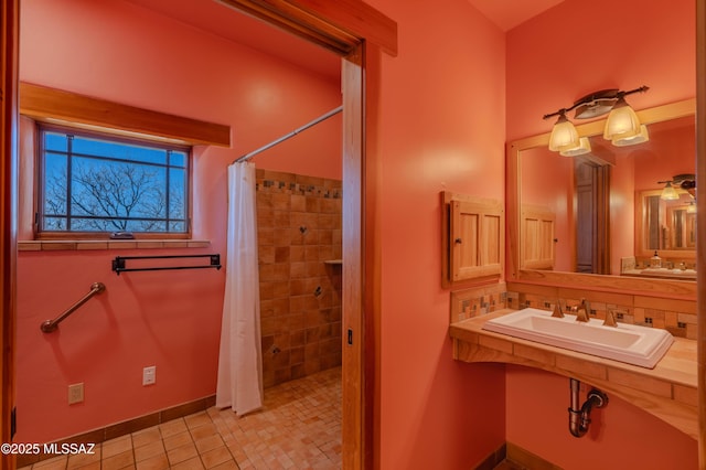 8060 E Diamondback Rd, Saint David, AZ 85630 - full bath with tile patterned flooring, a sink, baseboards, and a tile shower