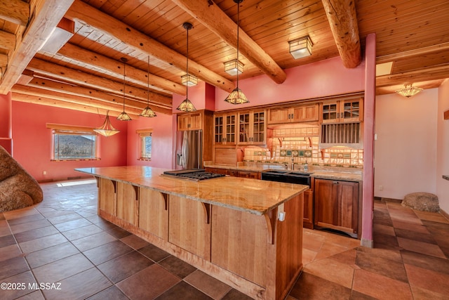 8060 E Diamondback Rd, Saint David, AZ 85630 - kitchen with brown cabinetry, a spacious island, backsplash, and stainless steel appliances