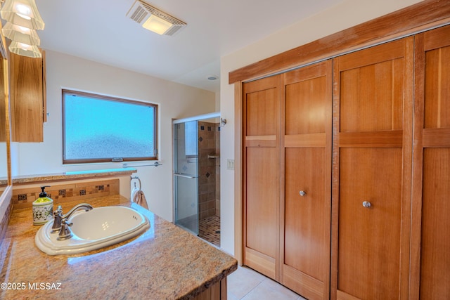 8060 E Diamondback Rd, Saint David, AZ 85630 - full bathroom featuring a sink, visible vents, a stall shower, and tile patterned flooring