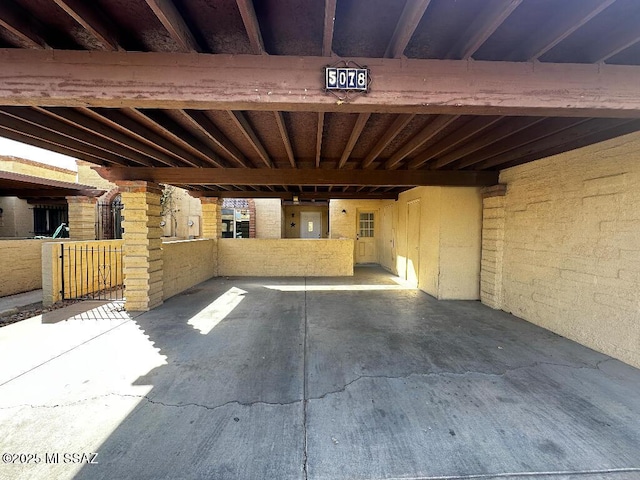 view of patio with electric panel and a carport