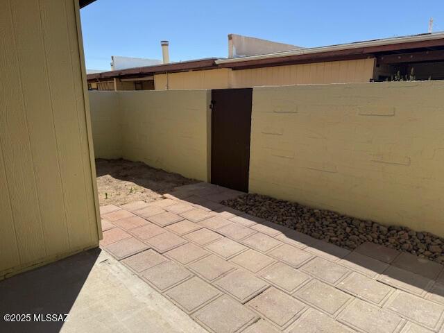 view of patio featuring fence