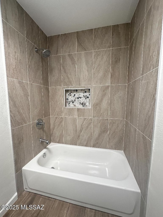 bathroom with wood finished floors and  shower combination