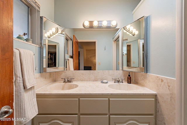 bathroom featuring a sink and double vanity