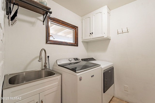 laundry area featuring a sink, cabinet space, and washing machine and clothes dryer