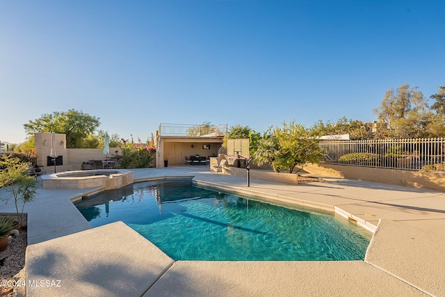 view of pool with a patio, a fenced backyard, and a pool with connected hot tub