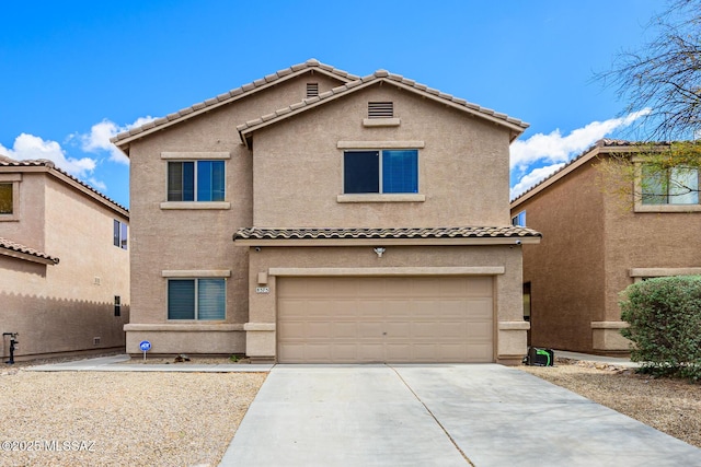 view of front of home with a tile roof, concrete driveway, a garage, and stucco siding