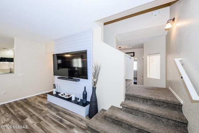 staircase featuring visible vents, wood finished floors, and baseboards