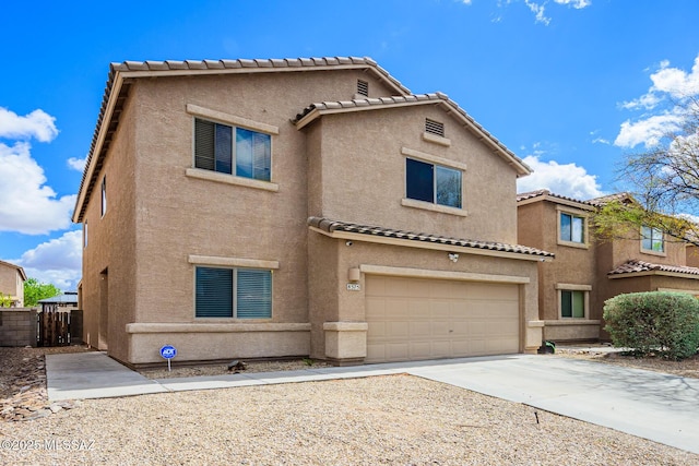 view of front facade with fence, a tile roof, concrete driveway, stucco siding, and an attached garage