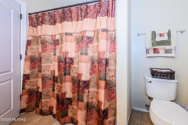 full bathroom featuring tile patterned floors, a shower with curtain, baseboards, and toilet