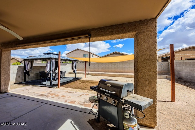 view of patio with a gazebo, grilling area, and a fenced backyard