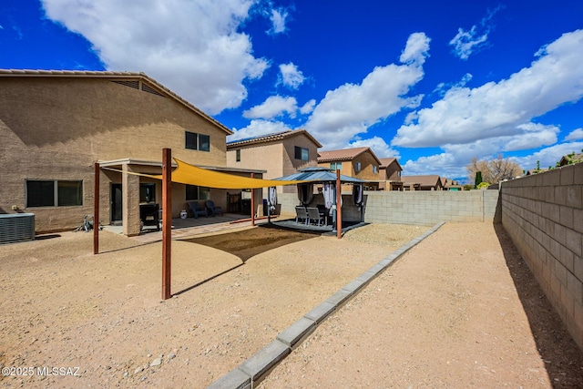 view of yard featuring a gazebo, a patio, a fenced backyard, and central AC