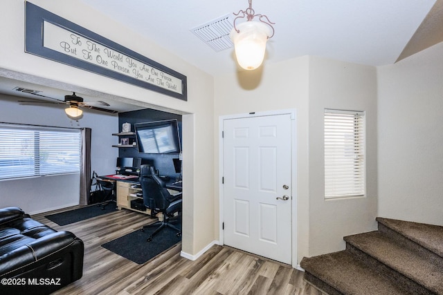 office space with visible vents, baseboards, wood finished floors, and a ceiling fan